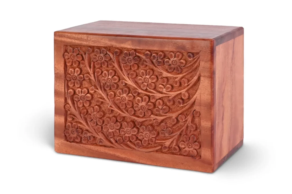 A pet urn: a wooden box adorned with intricate designs, serving as a final resting place for a beloved pet.